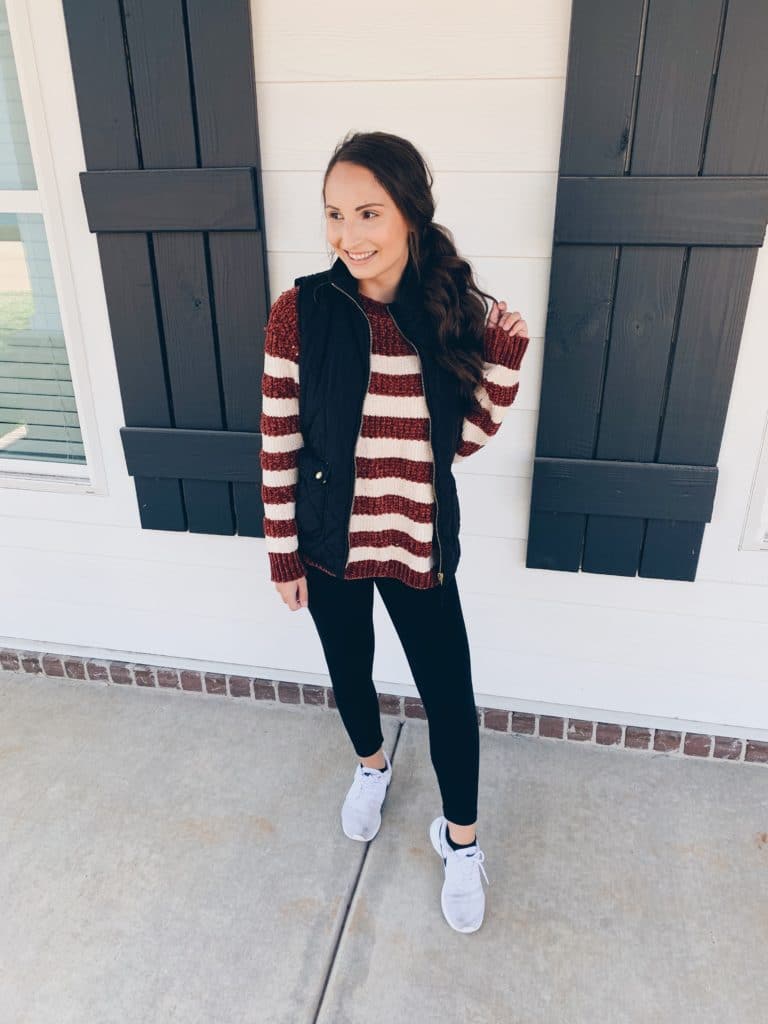 Chenille striped sweater paired with leggings, sneakers, and a vest for staying warm in the fall/winter