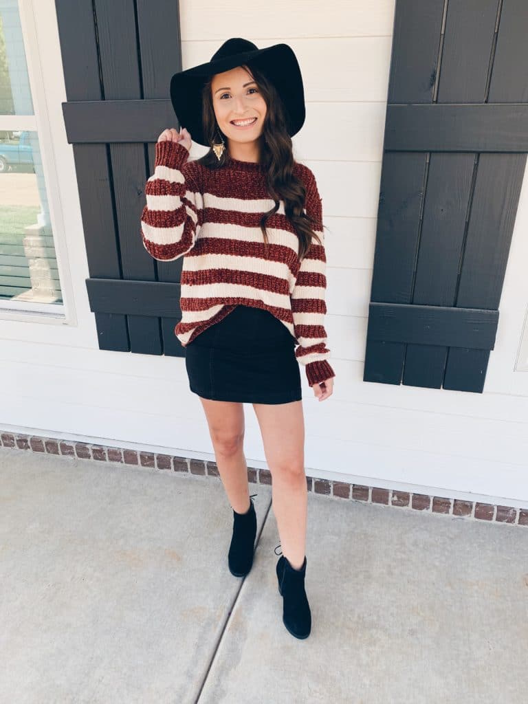 Chenille striped sweater paired with a black denim skirt, hat, and booties for fall