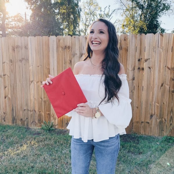 white off the shoulder ruffle top and red graduation cap university of alabama